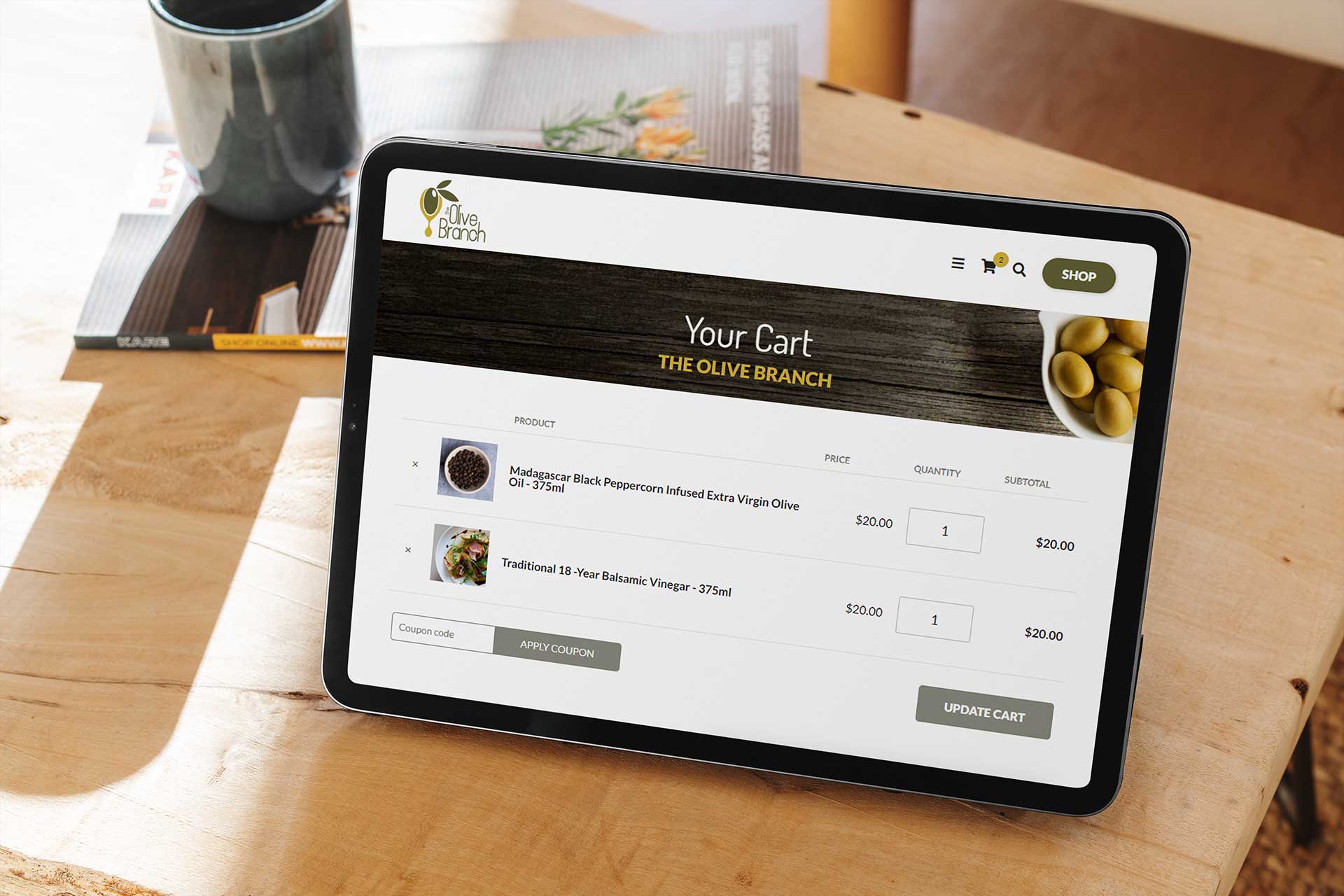 Tablet showing an online shopping cart with olive oil products.