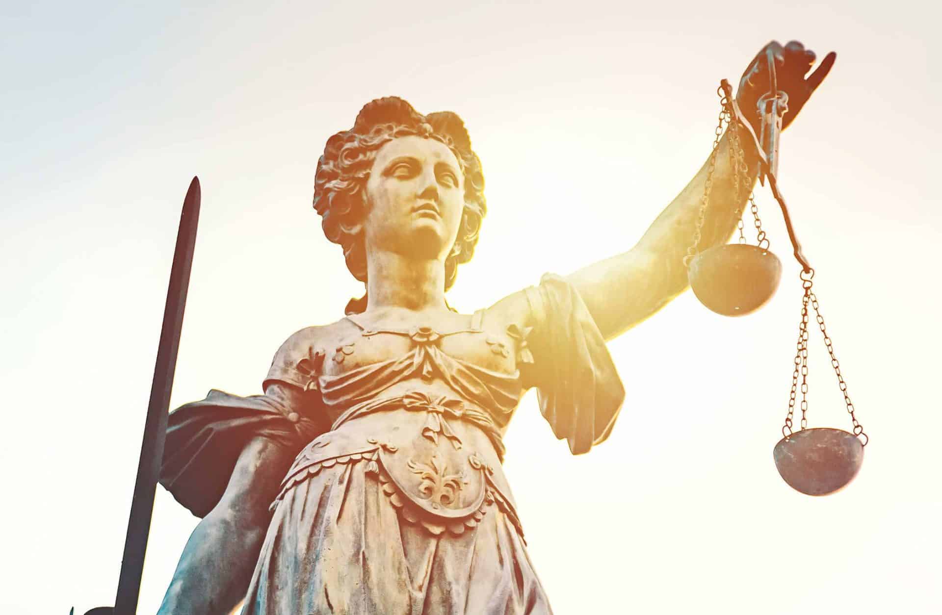 Lady Justice, emblem of Vanderpool Law Firm, holds scales and a sword.
