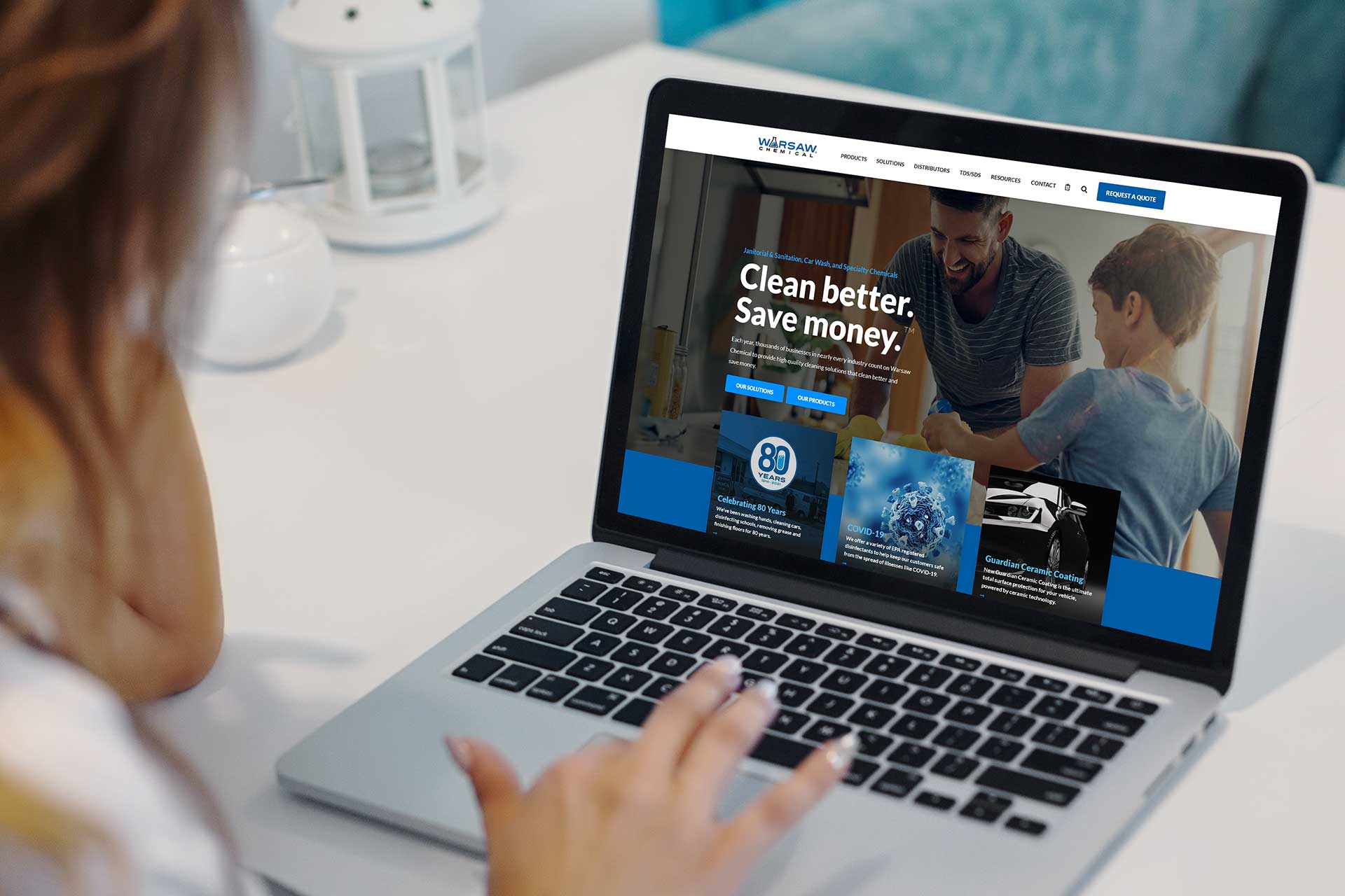 A person browsing Warsaw Chemicals website on a laptop at a table.